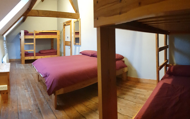 Six bed room with double bed and bunk beds in Deepdale Granary - Self catering group accommodation for up to 16 people on the beautiful North Norfolk Coast